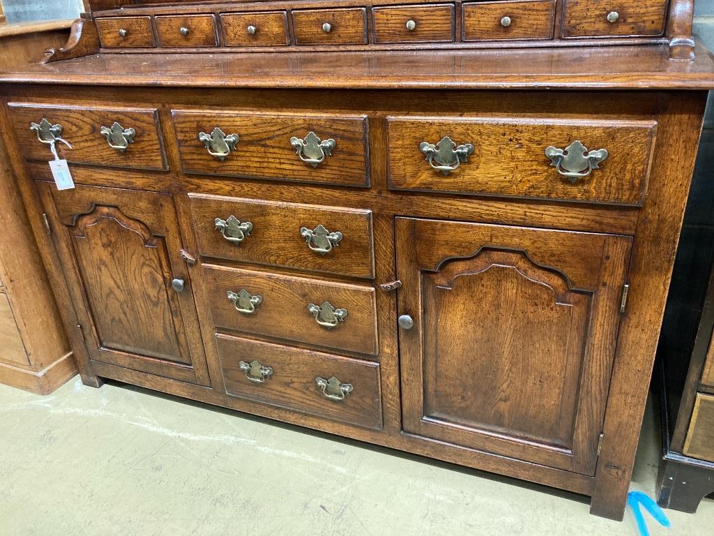 A reproduction 18th century style oak dresser, width 152cm, depth 54cm, height 198cm